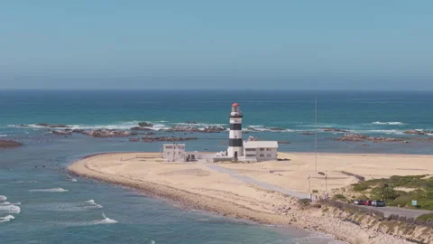 Drone Hovering with View of Distant Lighthouse, Sea, Waves, Coastline, Coastal R Stock Footage 306356398