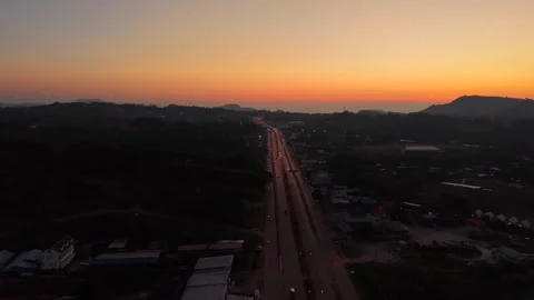 Drone hovers above highway through Khao Kho National Park during twilight as Stock Footage 309193604