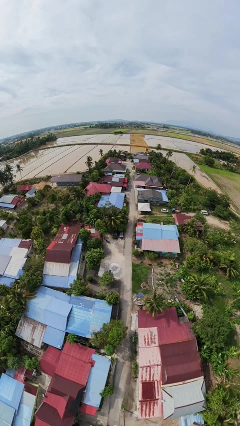 Drone hovers above small village with colorful roofs Stock Footage 345409248