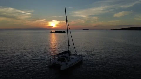 Drone hovers as catamaran floats during sunset near Likoma Island Stock Footage 337092785