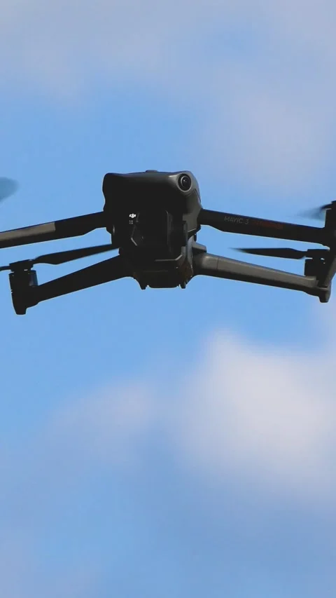 A drone hovers in a clear blue sky. Stock Footage 314044062