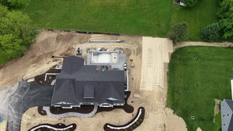Drone hovers directly above large custom home under construction, new pool Stock Footage 339143048