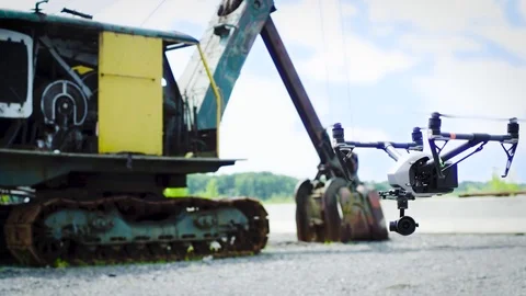 Drone hovers in front of old excavator truck Stock Footage 80151949