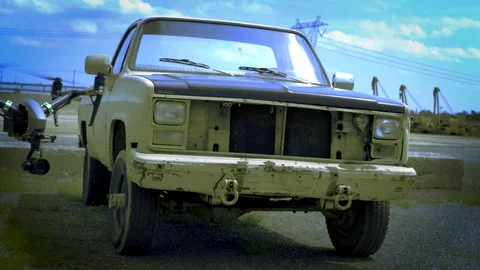 Drone hovers in front of old pickup truck. Exits right. Stock Footage 80151887