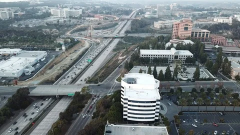 Drone hovers over a city view then pulls back to reveal the Mormon Temple towers Stock Footage 86132064