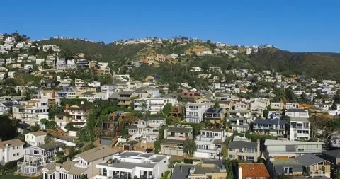 Drone hovers over a small coastal town at Laguna Beach, California, USA Video stock 157773010