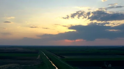 Drone  hyper lapse of agricultural fields and moving clouds in sky Stock Footage 126894183