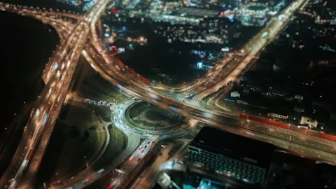 Drone hyperlapse car traffic roundabout junction highway intersection at night Video stock 169824758