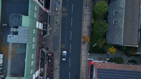 Drone hyperlapse city high street with cars and shops in England Stock Footage 319481838