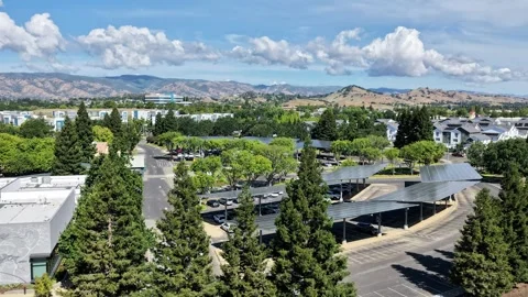 Drone hyperlapse of clouds and traffic near Vacaville Library. Stock Footage 335775295