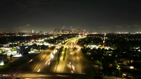 Drone hyperlapse of Houston city skyline and highway traffic at night Stock Footage 332874006