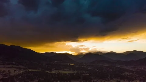 Drone hyperlapse looking over mountain range during beautiful colorful sunset Stock Footage 135266584