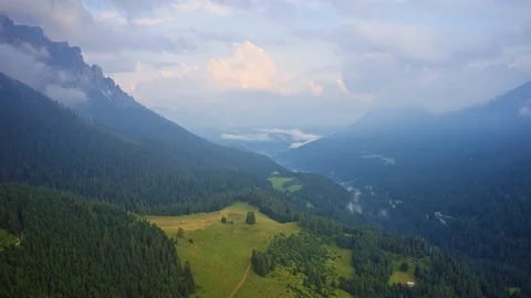 Drone hyperlapse of a mountain peaks in summer with meadow fields and trees Stock Footage 115481321
