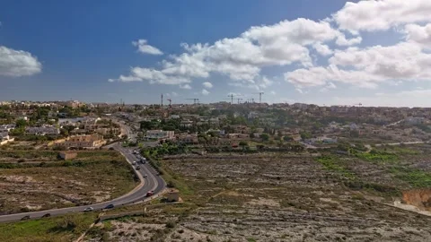 Drone hyperlapse from Naxxar, Malta, showing busy roads, limestone terrain and Stock Footage 320549961
