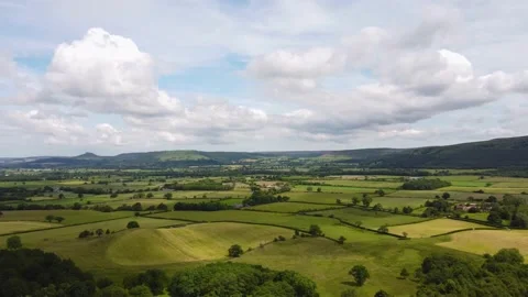 Drone hyperlapse over patchwork fields in North York Moors with clouds Stock Footage 169343813