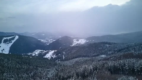 Drone hyperlapse over a snowy spruce forest in the Carpathians under cloudy Video stock 308394982