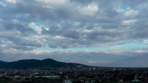 Drone hyperlapse panorama of the city on a hill with beautiful clouds Stock Footage 125484232
