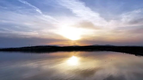 Drone image approaching the sun over a calm and smooth sea in the Aegean Sea Stock-Footage 241494573