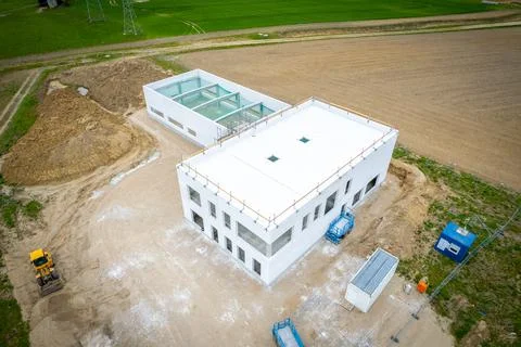 Drone image of a construction site on which a company building is being erect Stock Photos