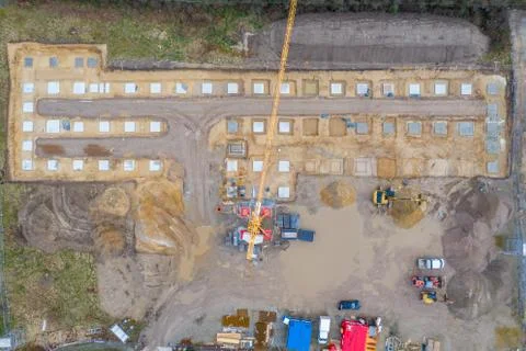Drone image of a large construction site on which the concrete foundation for Stock Photos