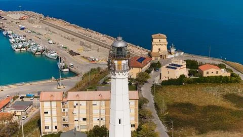 Drone image of Vasto harbor featuring port infrastructure, lighthouse, boat.. Stock Photos