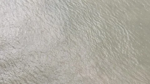 Drone image from a zenith angle of the water movement, which is a bit cloudy Stock Footage 306314456