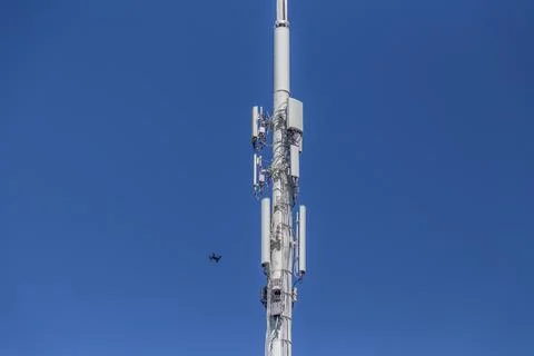 Drone Inspecting lower left side of a cell tower Stock Photos