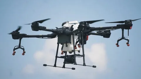 Drone for irrigation on the farm field Stockbeeldmateriaal 255621050