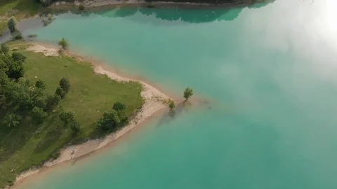 Drone on lake coast, green water, Castel San Vincenzo lake Stock Footage