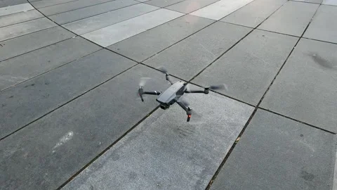 Drone landing on a ground and propellers stop spinning. Stock Footage 145658216