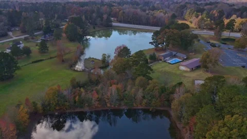 Drone Landscape over fall lake facing pretty fall lake with street in background Stock Footage 170461738
