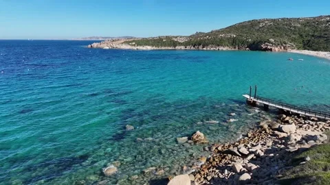 Drone Lateral Flight Over Crystal Waters and Jetty on the Coast of Sardi Vídeo Stock 334127819