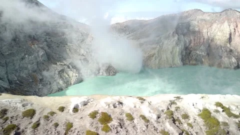 Drone Lateral Flight Over Volcanic Crater Lake with Smoke Stock Footage 315224374