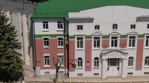 Drone lateral flight past building and street Stock Footage 333959633