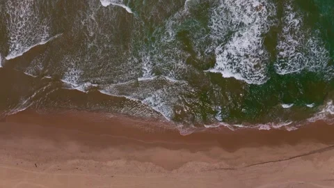 Drone Lateral Tracking Shot Capturing Ocean Rhythm and Coastal Serenity Stock Footage 315513765