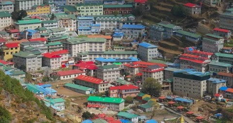 Drone lateral tracking shot of Namche Bazaar Nepal showing colorful roofs and Stockbeeldmateriaal 337394341