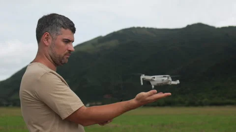 A drone lifting off from a mans hand. Video stock 321858213