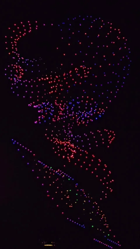 Drone Light Show: Abstract Swirls and Spiral Formations in the Night Sky Stock Footage 341596525