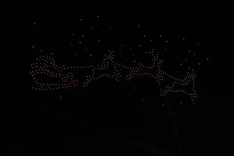 Drone Light Show Creating Santa's Sleigh and Reindeer Silhouette Stock Photos