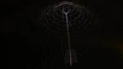 Drone Light Show Forming a Giant Arrow in the Dark Night Sky Stock Footage 343627299