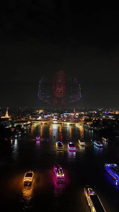 Drone Light Show Forming Thai Cultural Icons Over River in Bangkok, Thailand Stock Footage 335969782
