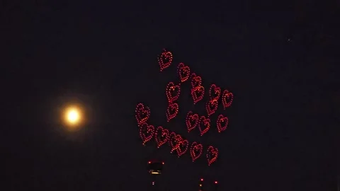 Drone Light Show of Many Red Hearts Near the Moon in the Night Sky Stock Footage 341529981