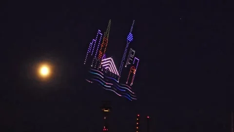 Drone Light Show in the Shape of a City Skyline Near the Moon in the Night Sk Stock Footage 341529951