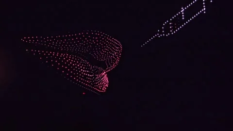 Drone Light Show in the Shape of Lips and a Syringe in the Night Sky Stock Footage 341529946