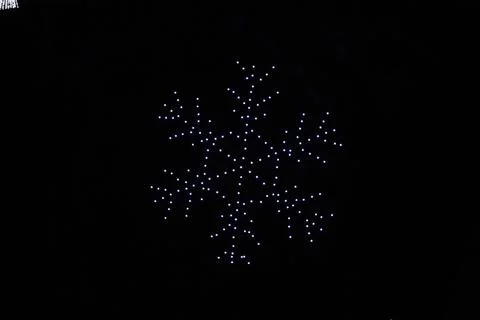 A drone lightshow arranged in the shape of a snowflake Stock Photos