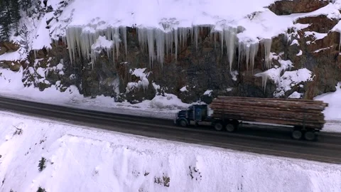 Drone:  Logging Truck Passes Large Icicles On Mountain Pass Stock Footage 265111324