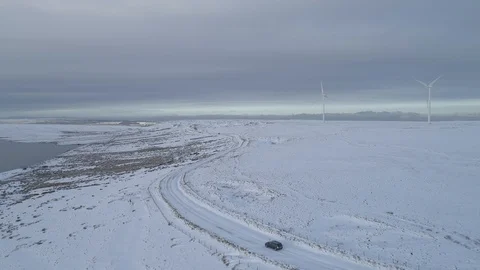 Drone Lonely car driving through the snow Stock Footage 89350382