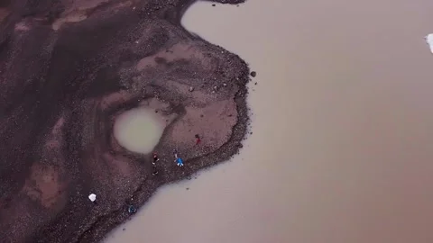 Drone long shot turning arround people near Solheimajokull lake in Iceland,2K Stock Footage 148762595