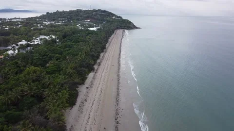 A drone looking down at a beach until camera points up and shows the whole beach Stock Footage 135494190