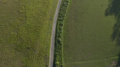 Drone looking down on country road in summer Stock Footage 135808515